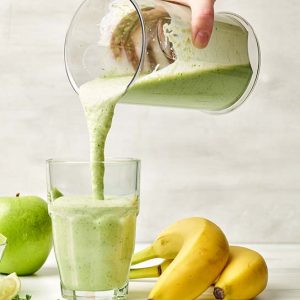fresh-green-smoothie-pouring-into-glass-4ALM7TA